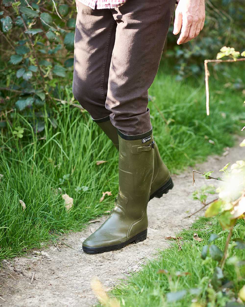 Khaki coloured Aigle Benyl Wellington Boots on grassy background