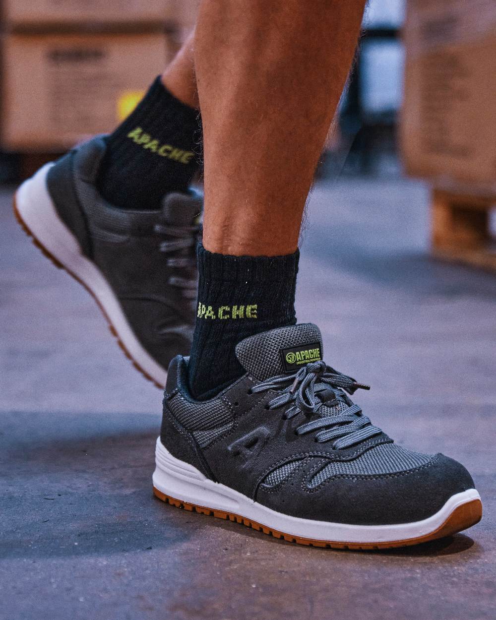 Charcoal Grey Coloured Apache Mens Winnipeg Suede Safety Trainer Shoes on warehouse background