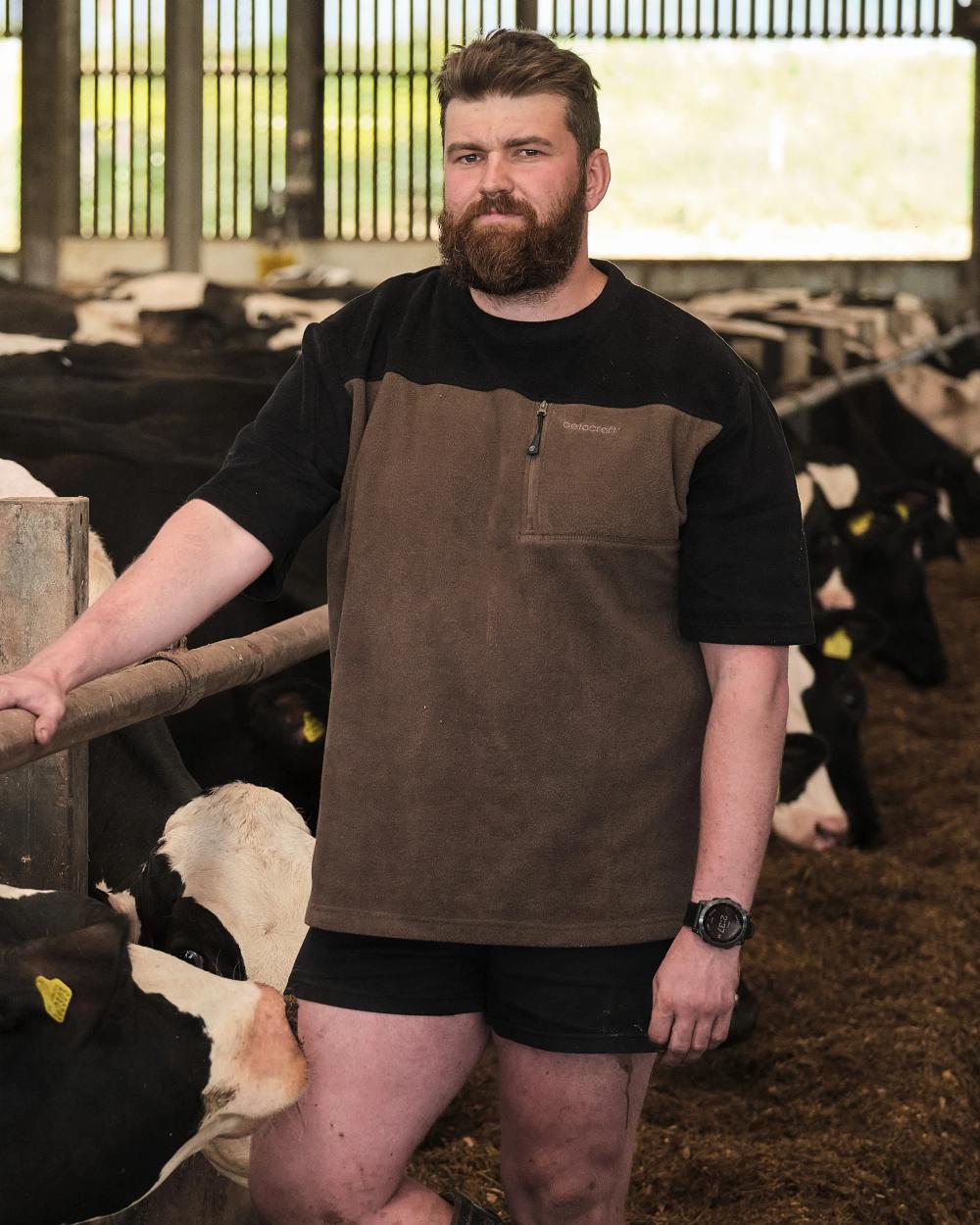 Olive coloured Betacraft Quest ECO Fleece T-Shirt on cowshed background