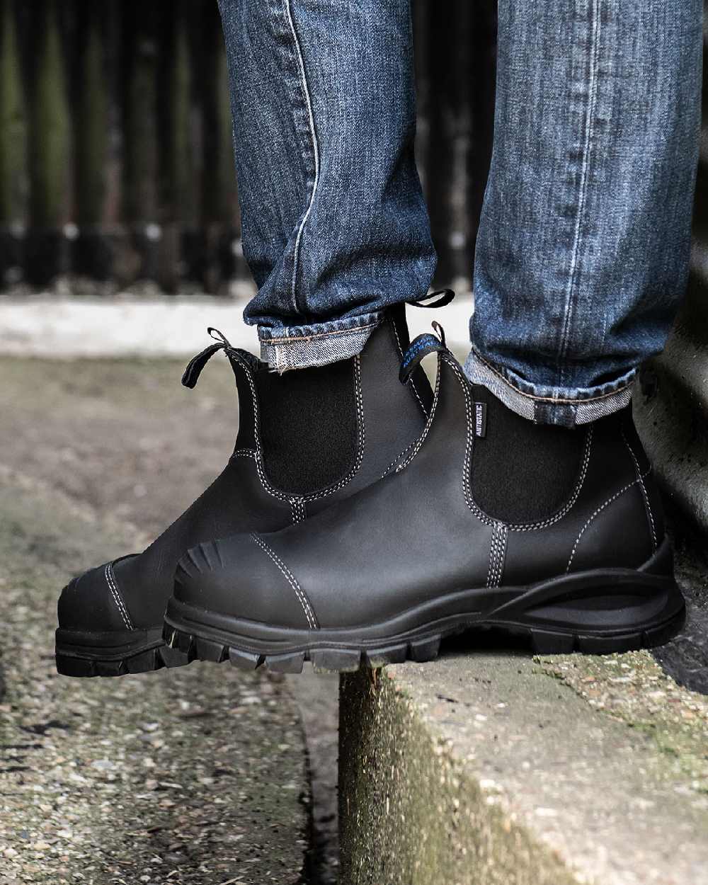 Black coloured Blundstone 910 Black Platinum Safety Boots on street background