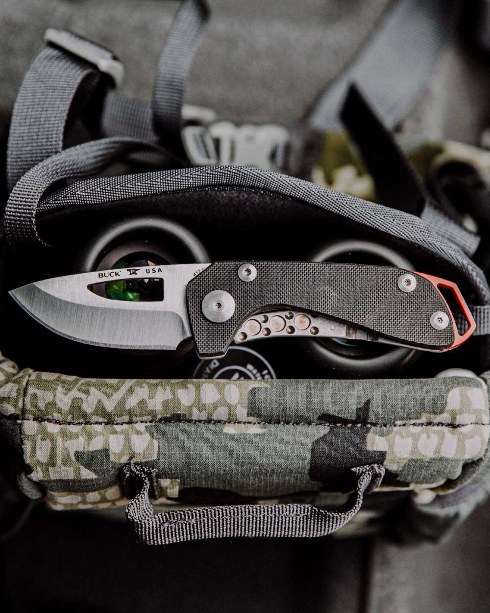 Black coloured Buck Budgie Knife on bag background