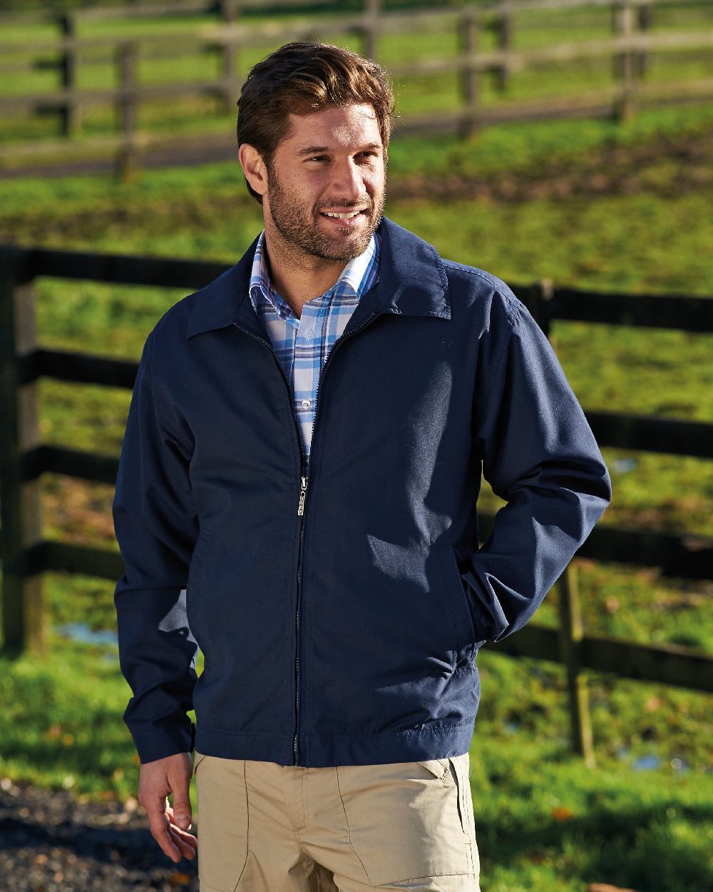 Navy coloured Champion Birkdale Lightweight Jacket on lawn background