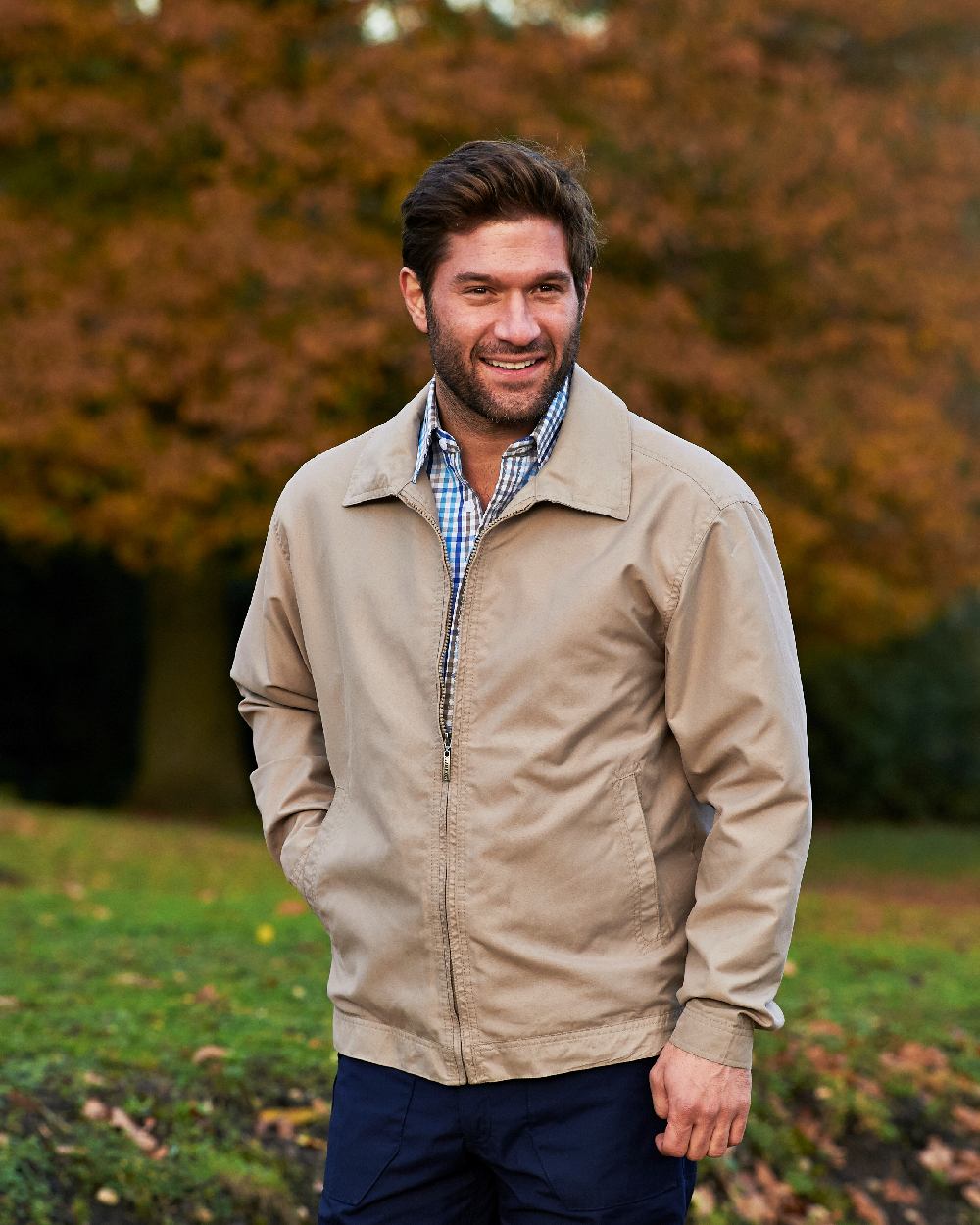 Stone coloured Champion Birkdale Lightweight Jacket on forest background