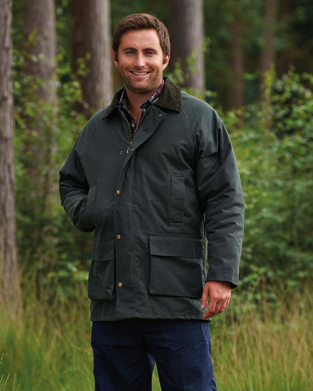 Green coloured Champion Howick Waxed Cotton Jacket on forest background