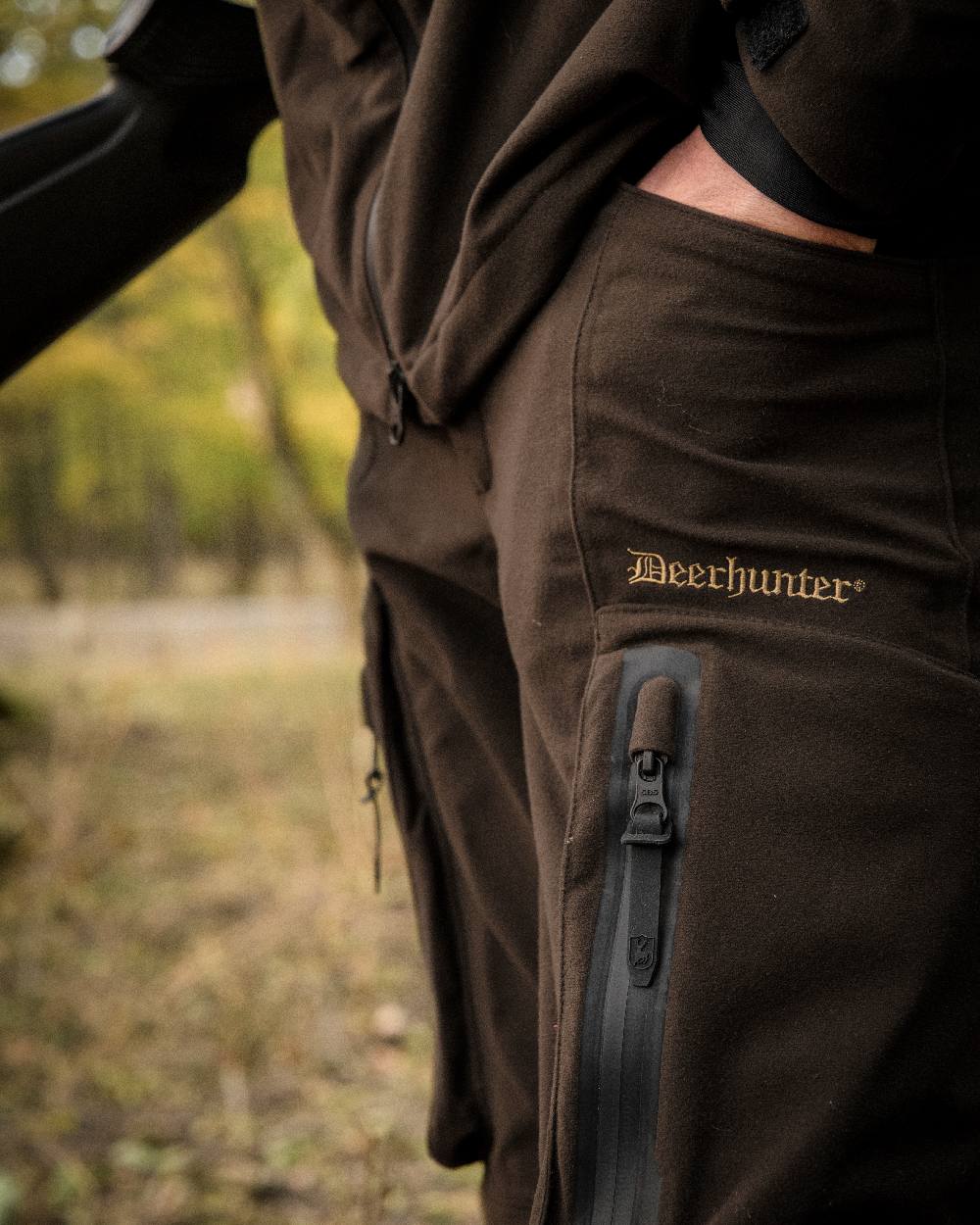 Wood coloured Deerhunter Game Pro Light Trousers on blurry background