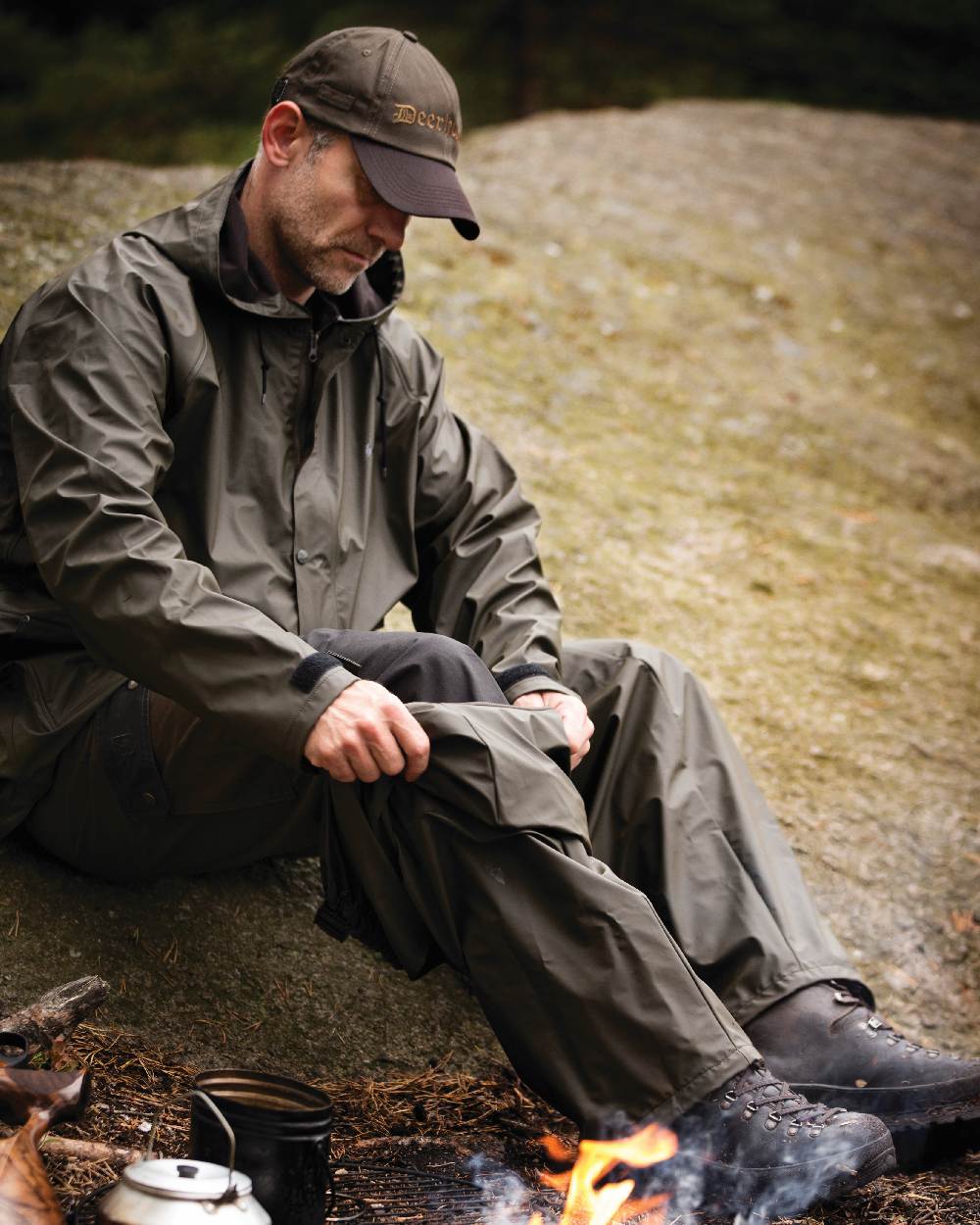 Art Green coloured Deerhunter Hurricane Rain Jacket on rock background
