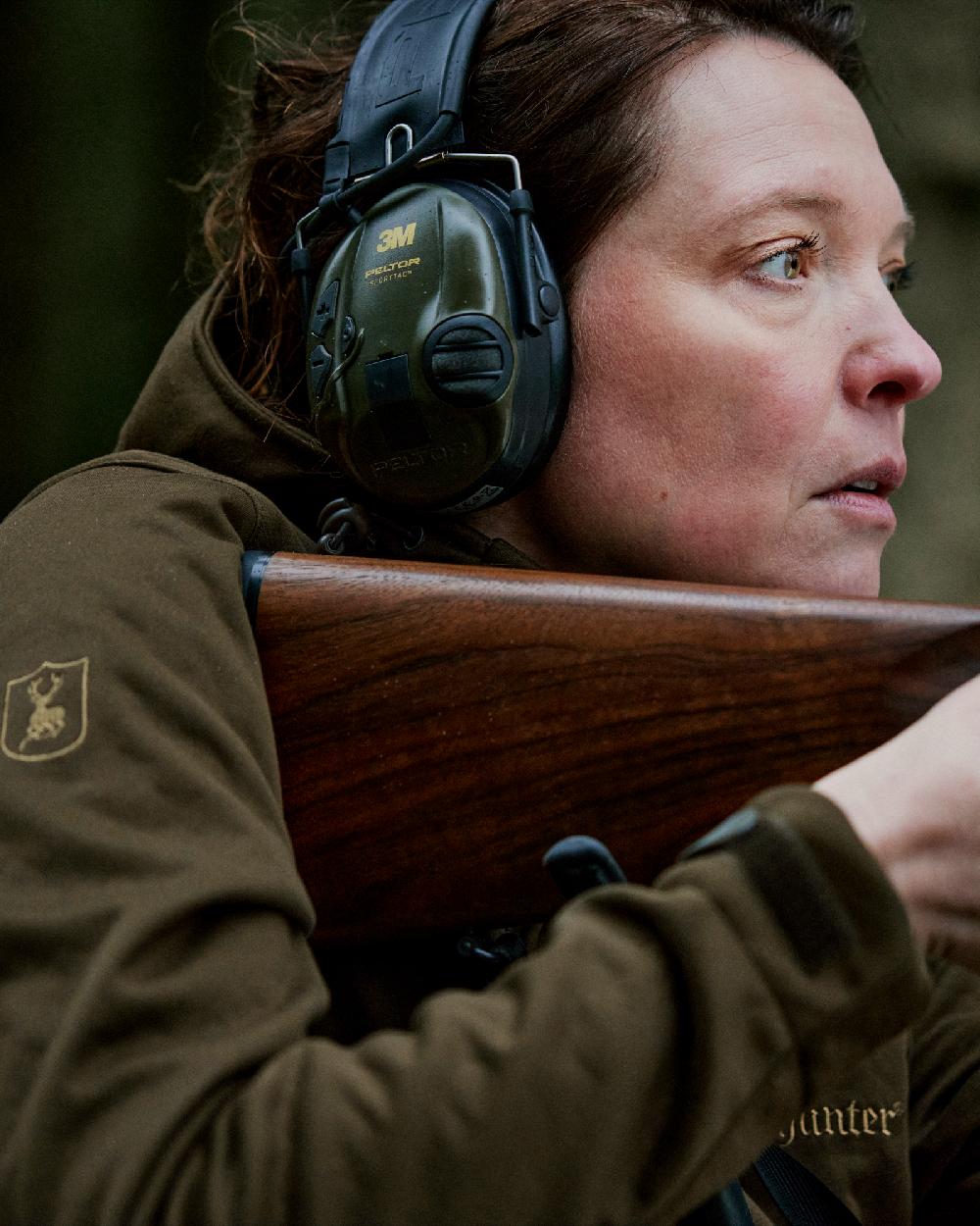 Art Green coloured Deerhunter Lady Excape Softshell Jacket on blurry background
