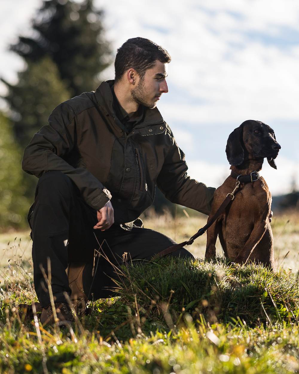 Black coloured Deerhunter Strike Full Stretch Trousers on forest background