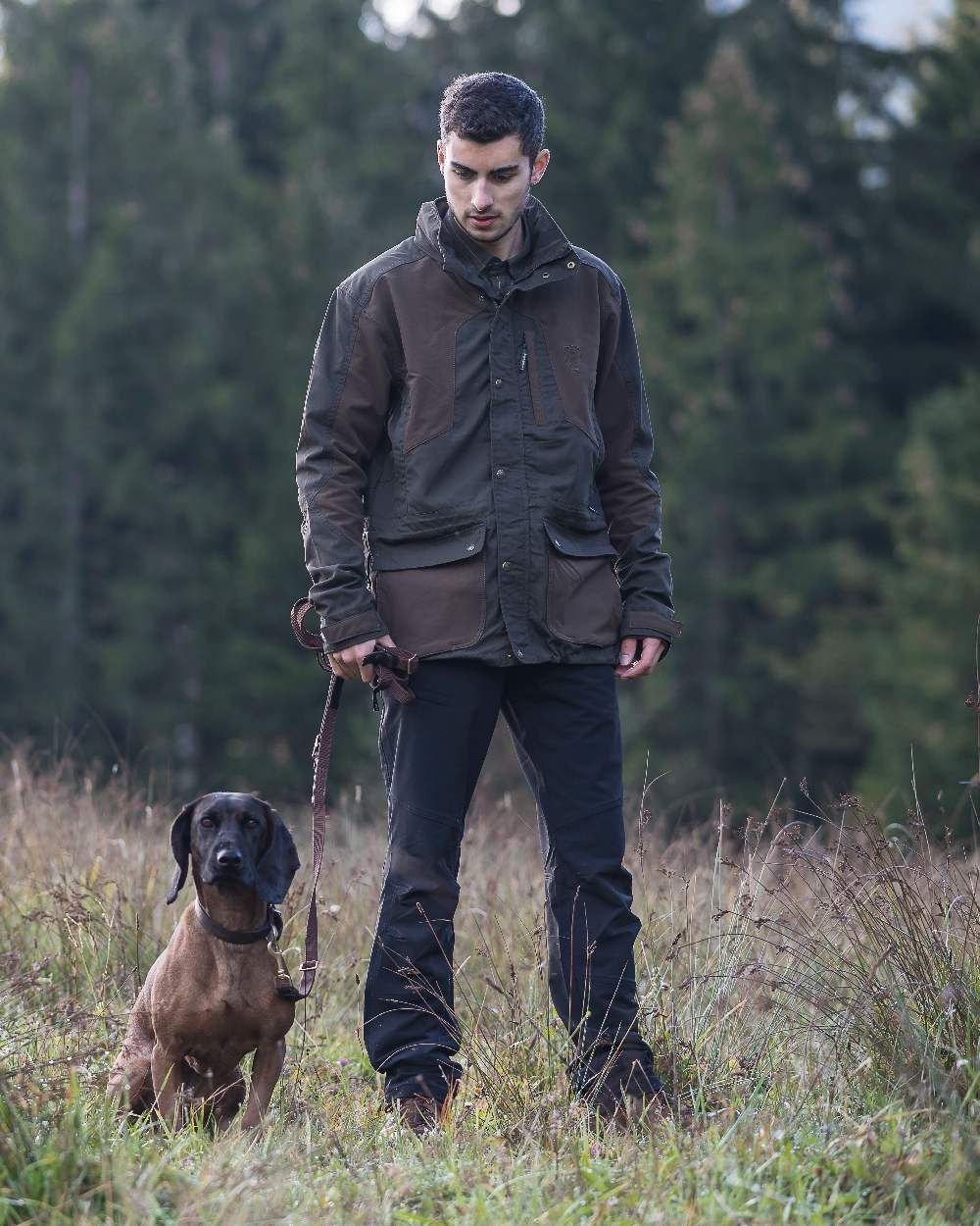 Black coloured Deerhunter Strike Full Stretch Trousers on forest background