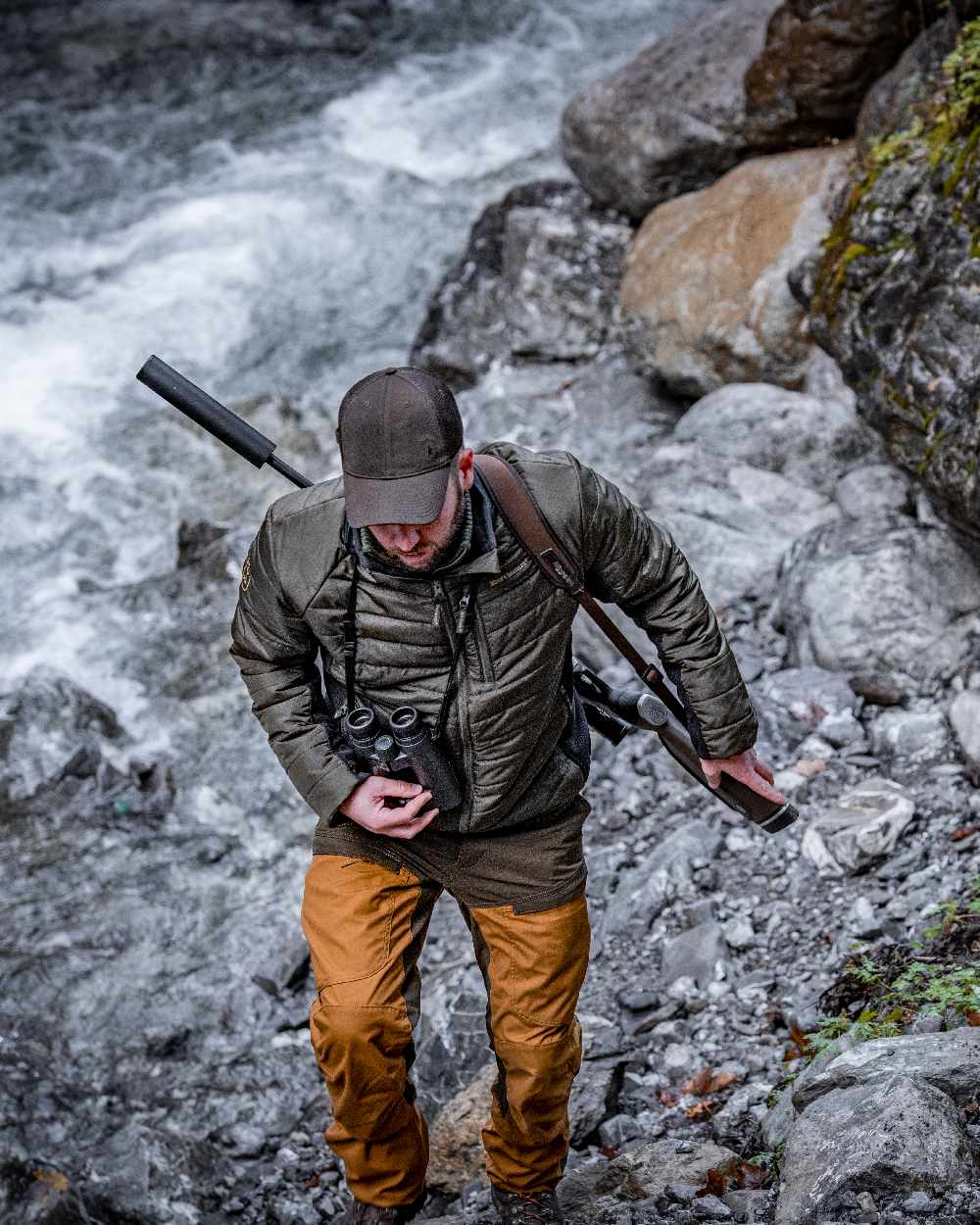 Bronze coloured Deerhunter Strike Trousers on waterfall background