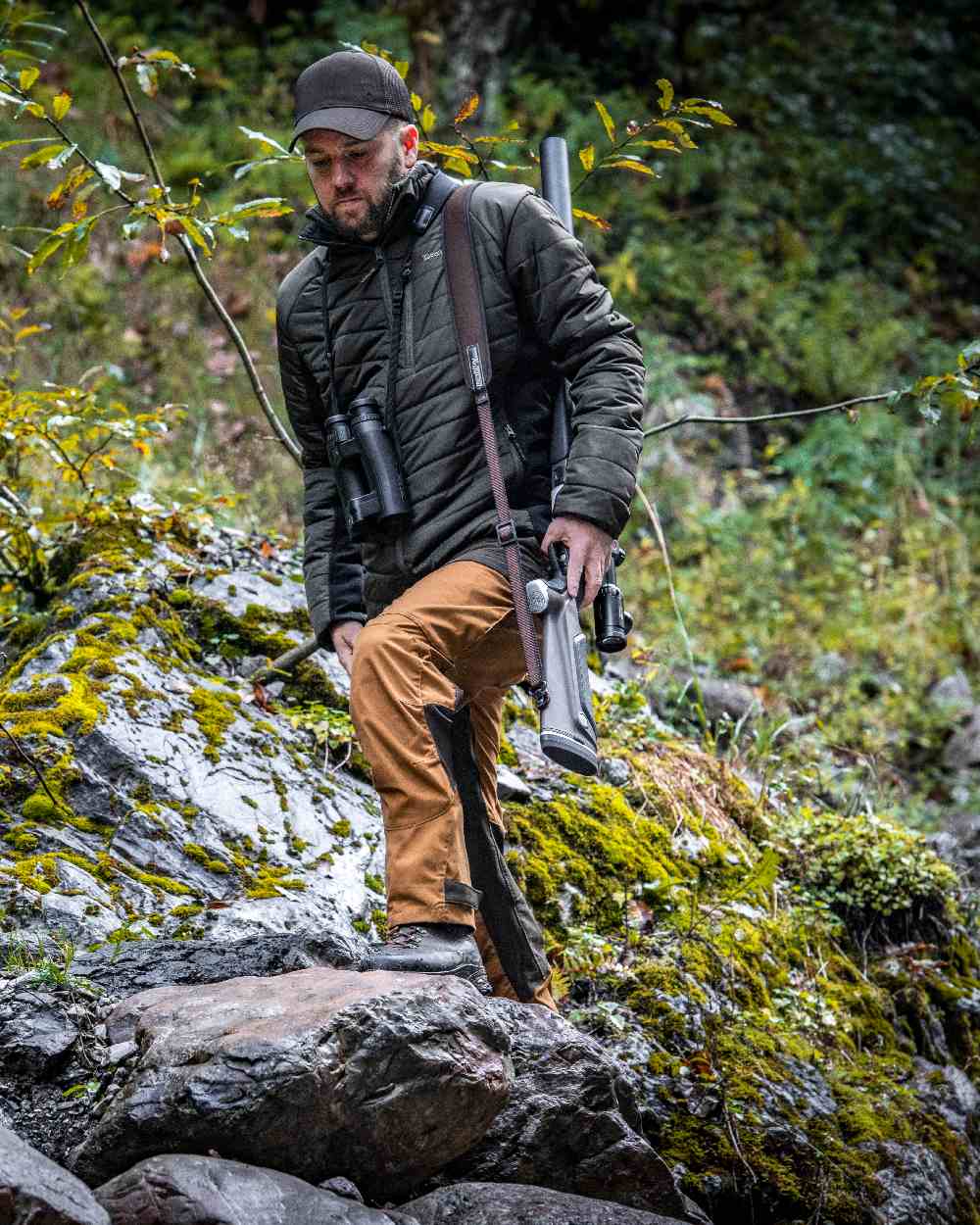 Bronze coloured Deerhunter Strike Trousers on forest background