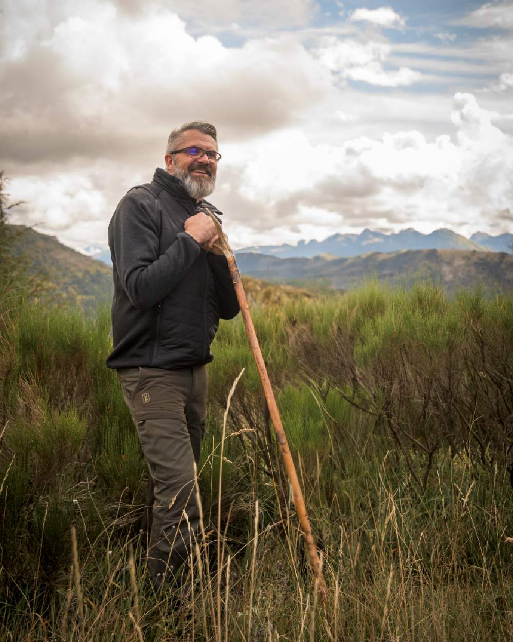 Deep Green coloured Deerhunter Strike Trousers on grassy background