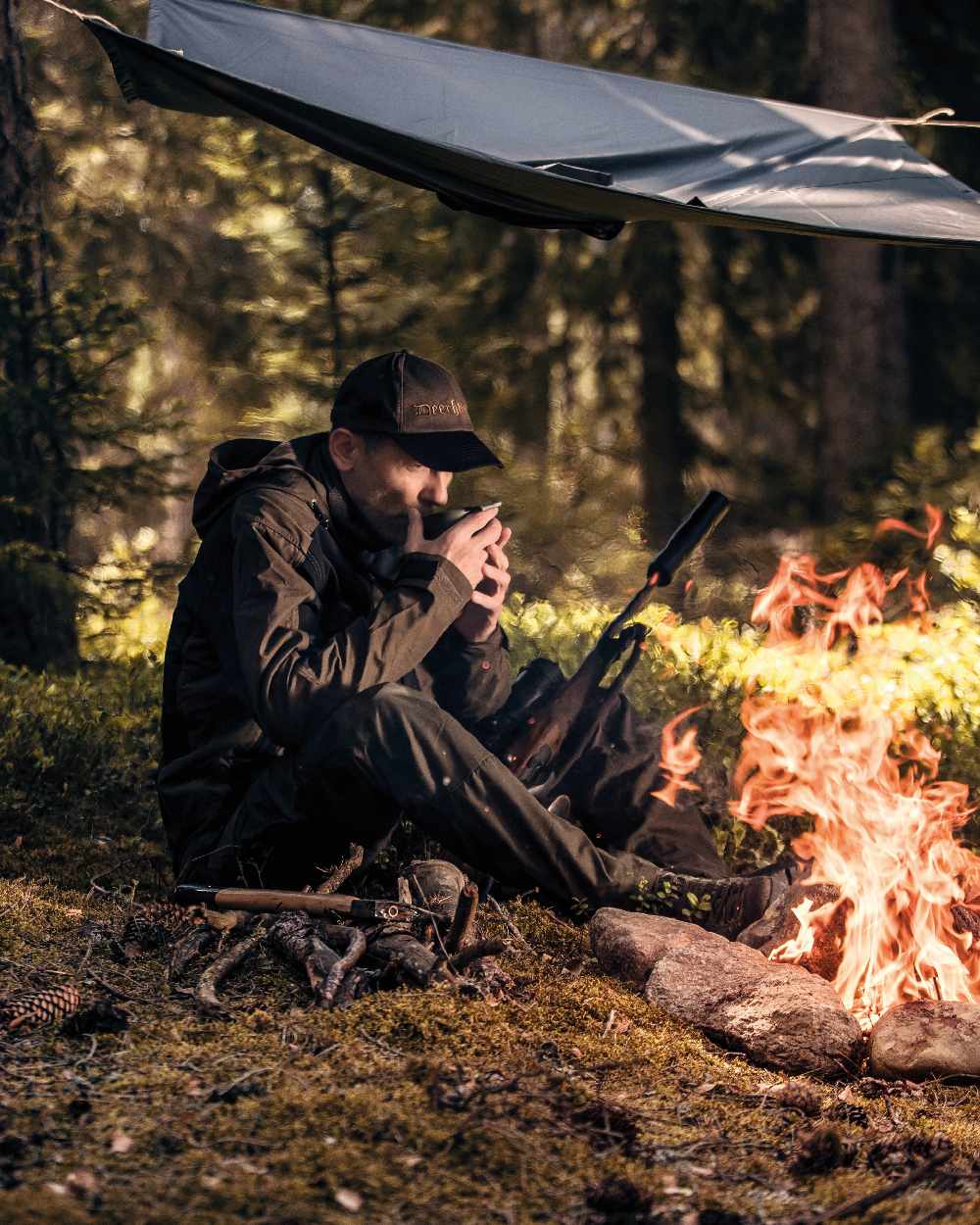 Timber coloured Deerhunter Survivor Rain Poncho on forest background