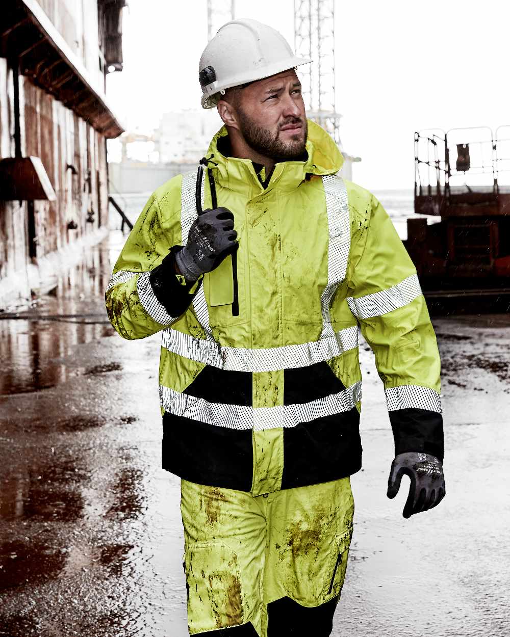 Fluorescent Yellow Black Coloured Elka Mens Visible Xtreme Stretch Jacket on construction background