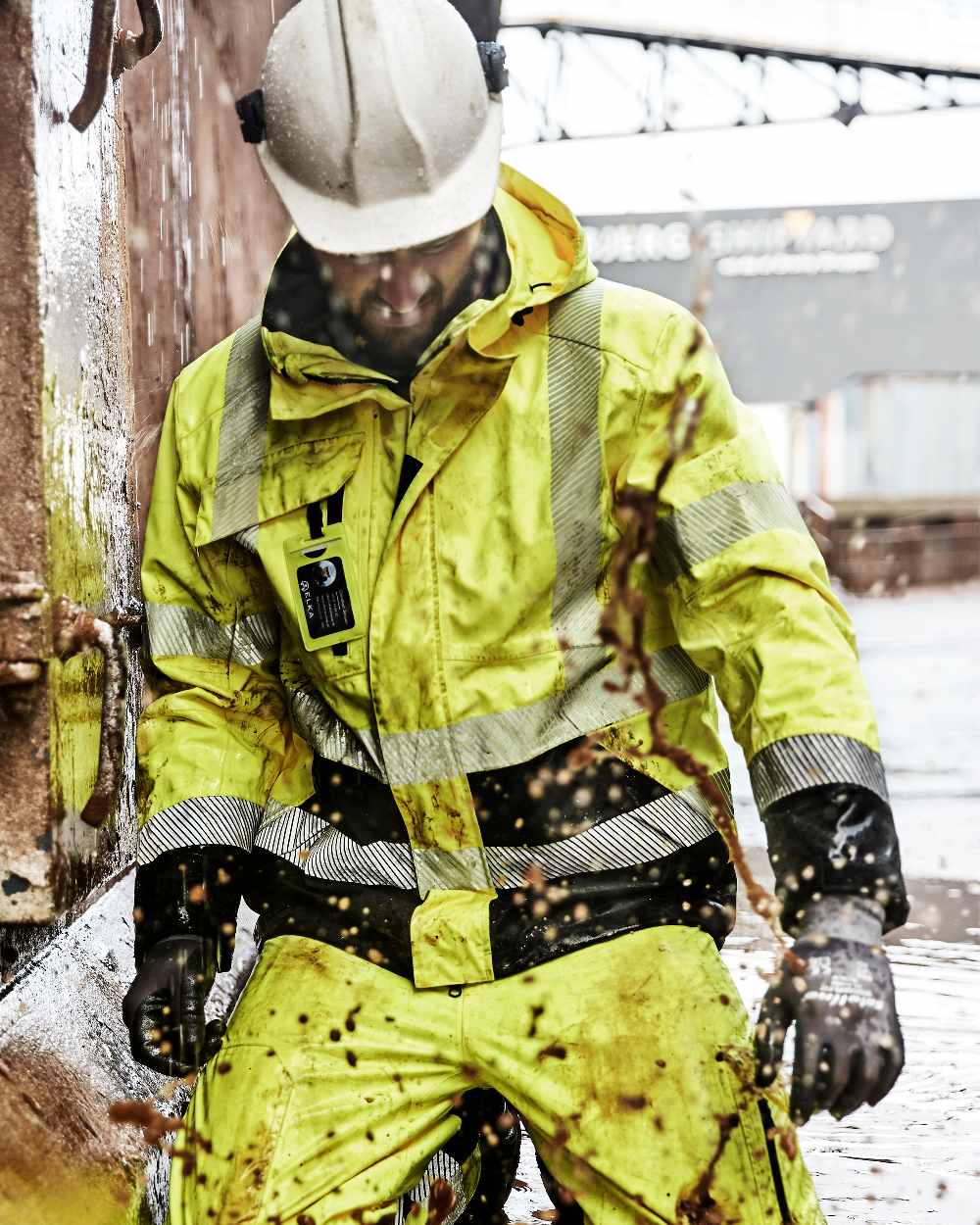Fluorescent Yellow Black Coloured Elka Mens Visible Xtreme Stretch Jacket on construction background
