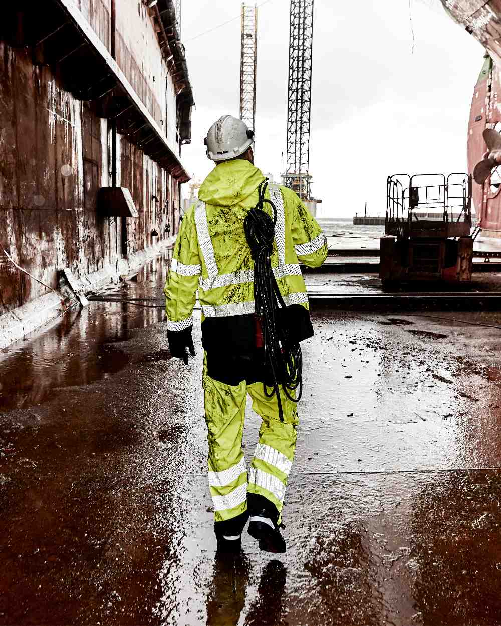 Fluorescent Yellow Black Coloured Elka Mens Visible Xtreme Stretch Jacket on construction background