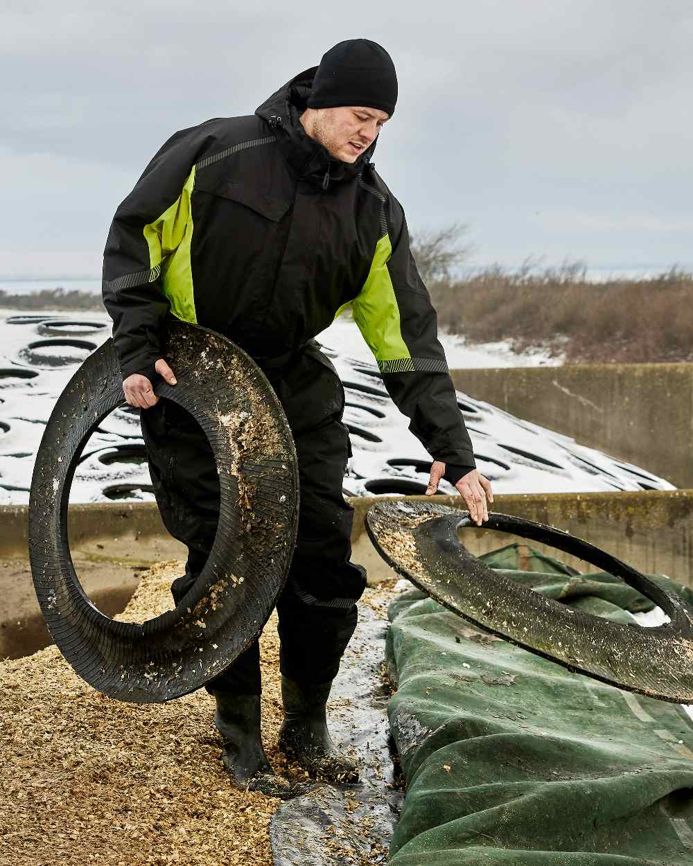 Black Fluorescent Yellow Coloured Elka Mens Working Xtreme Winter Thermal Coverall With Recycled Padding on snow background