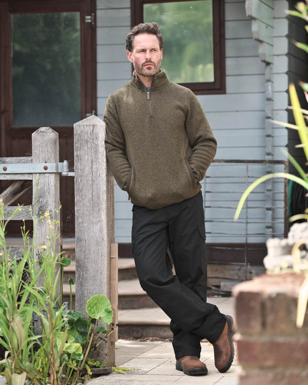 Green coloured Fort Easton Half Zip Fleece Pullover on house background