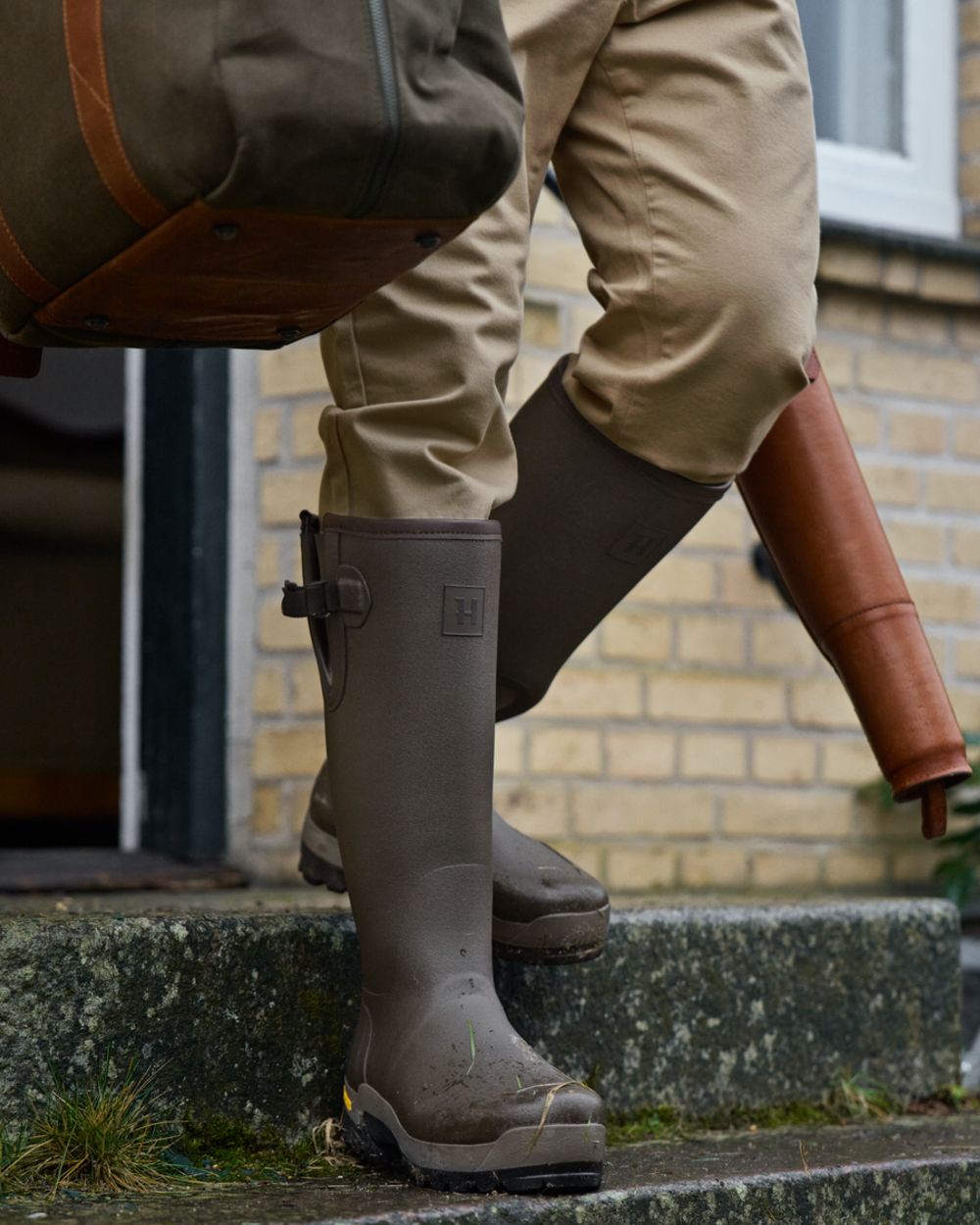 Dark Willow Green Coloured Harkila Forester Gusset Rubber Boots on outdoor background