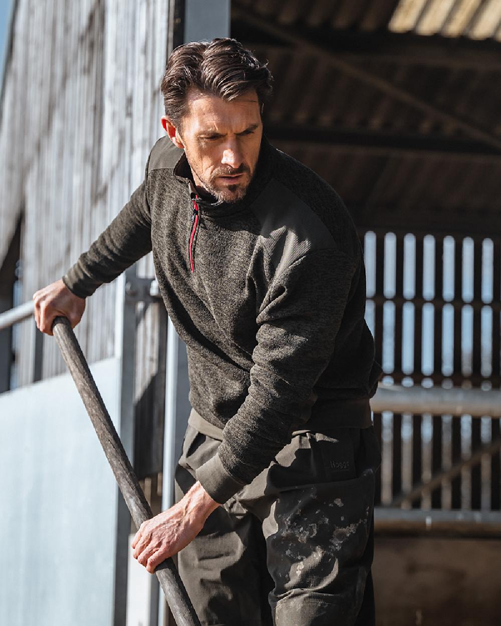 Green coloured Hoggs of Fife Green King II Quarter Zip Knit Fleece on barn background