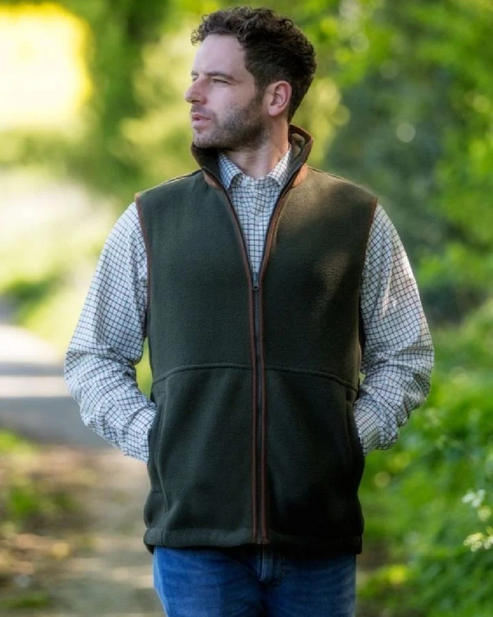 Pine Green coloured Hoggs of Fife Stenton Technical Fleece Gilet on blurry background
