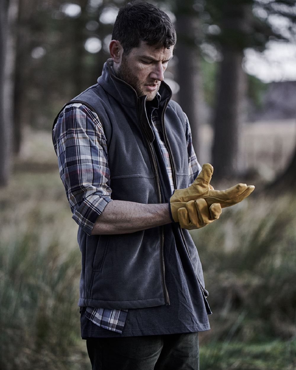 Slate Grey coloured Hoggs of Fife Stenton Technical Fleece Gilet on forest background