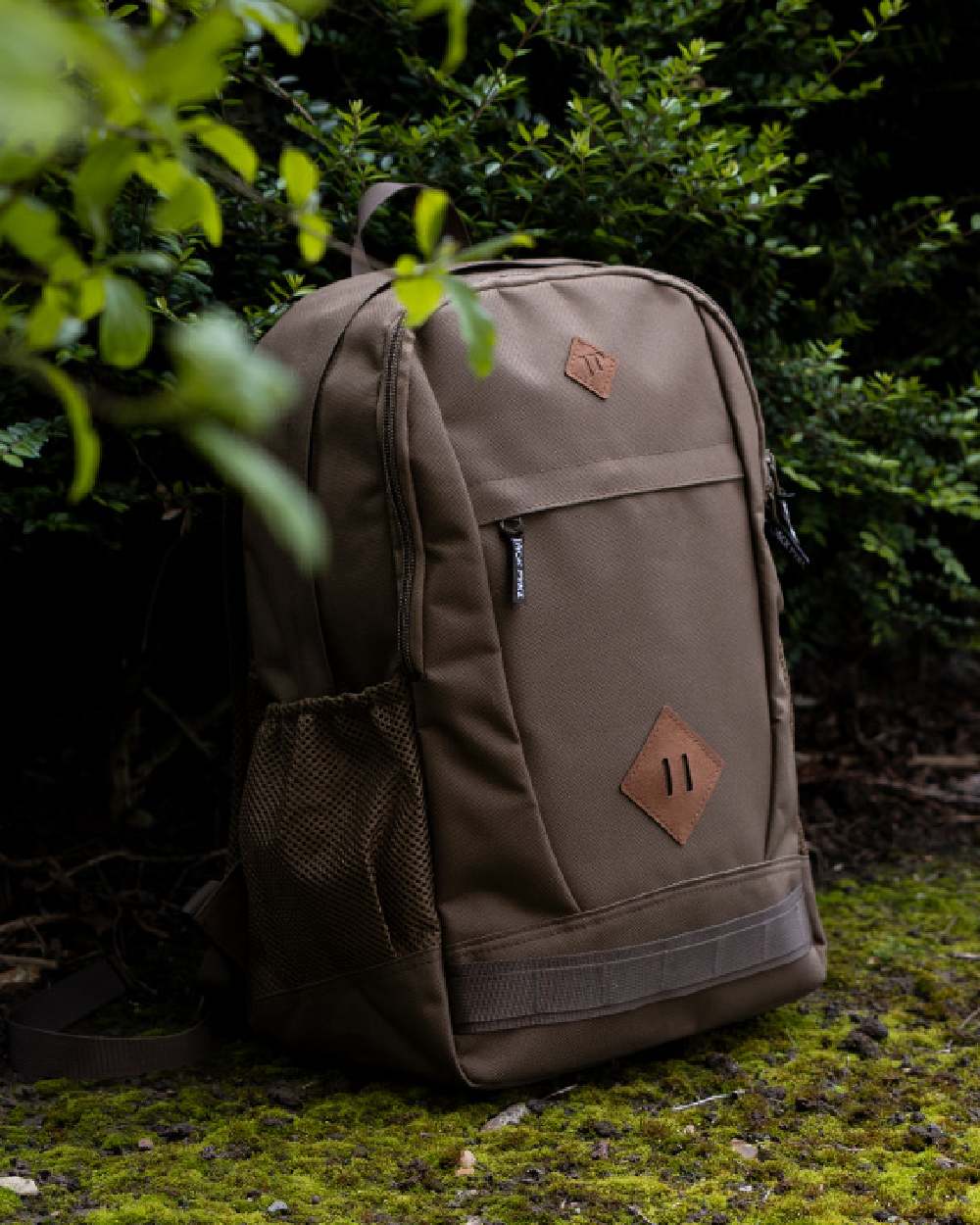 Olive Brown coloured Jack Pyke Falcon Rucksack on leafy background