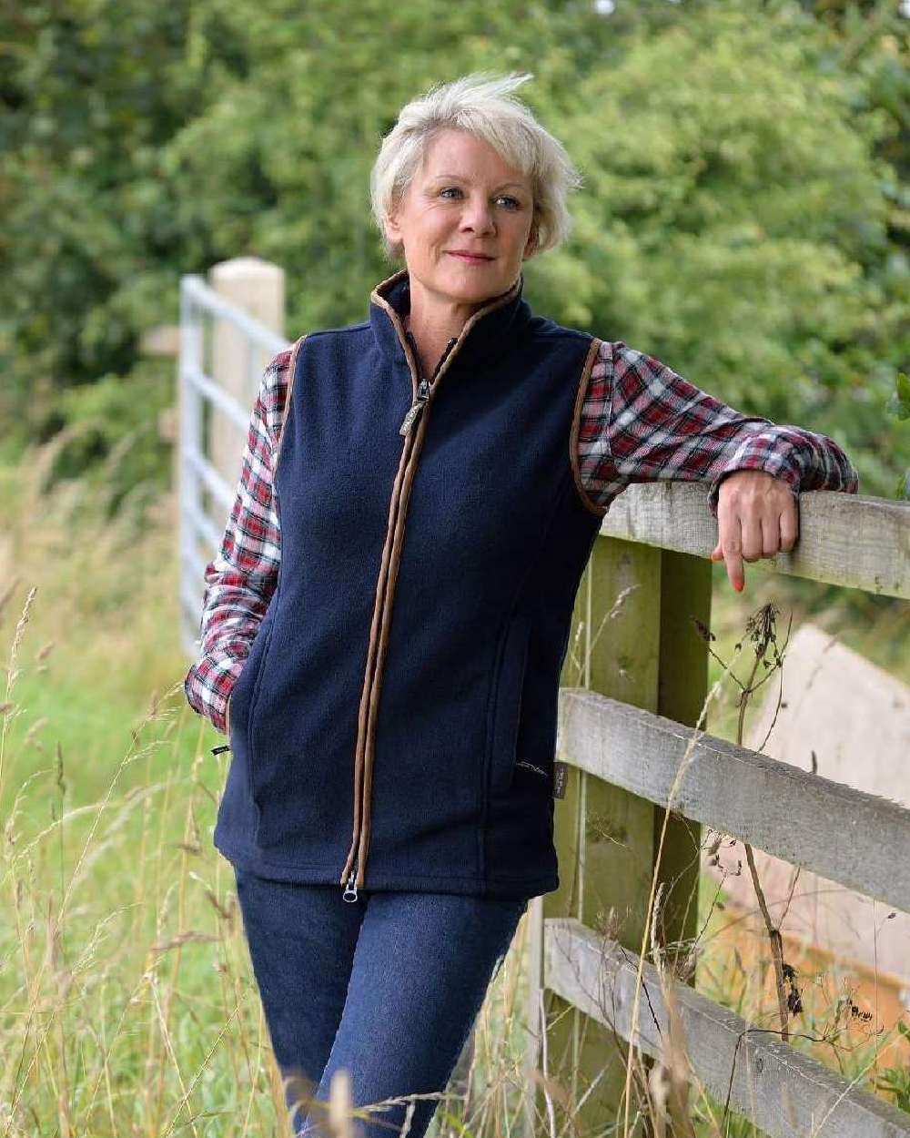 Navy coloured Jack Pyke Ladies Countryman Fleece Gilet on fences background