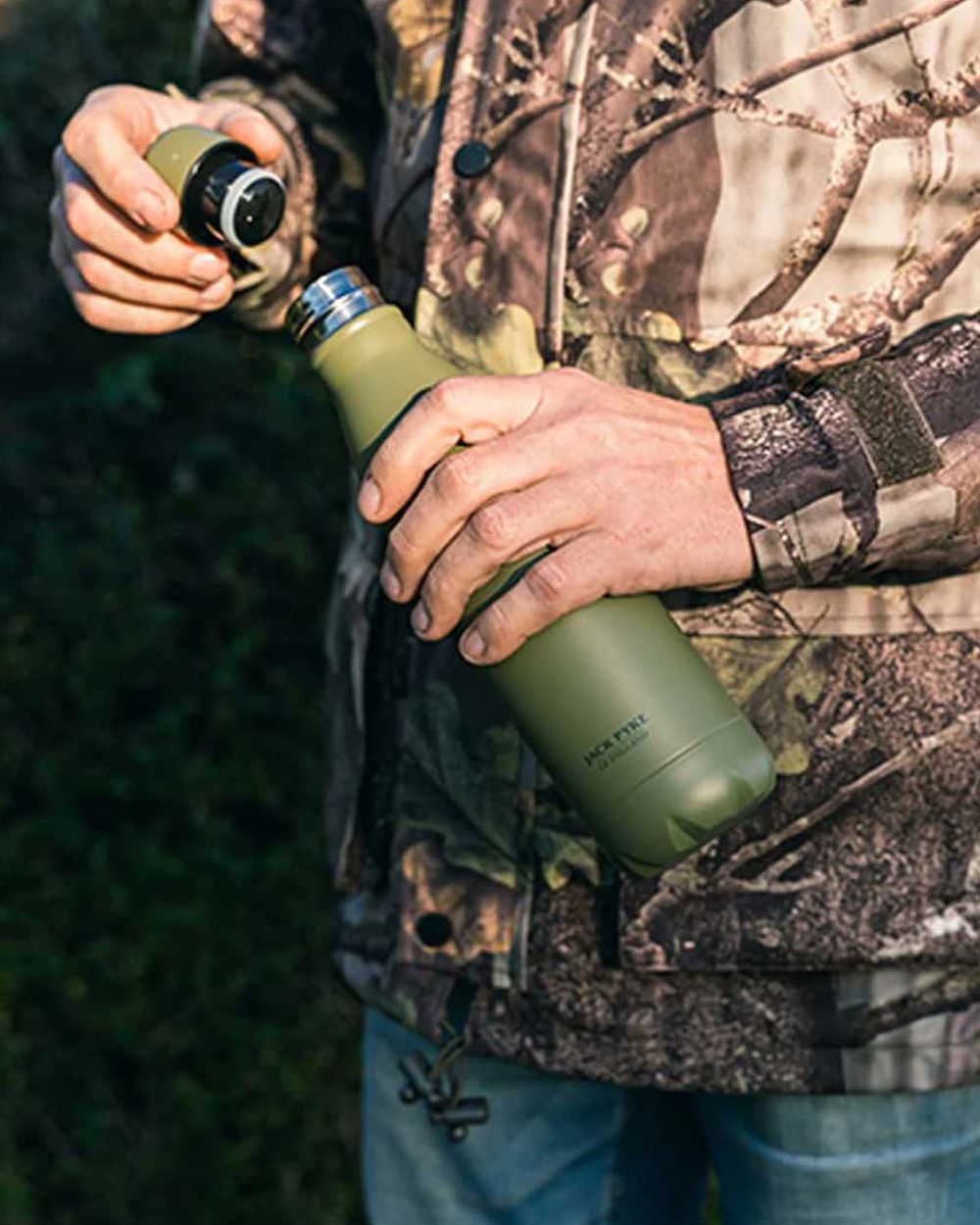 Matt Green coloured Jack Pyke Thermal Bottle on blurry background