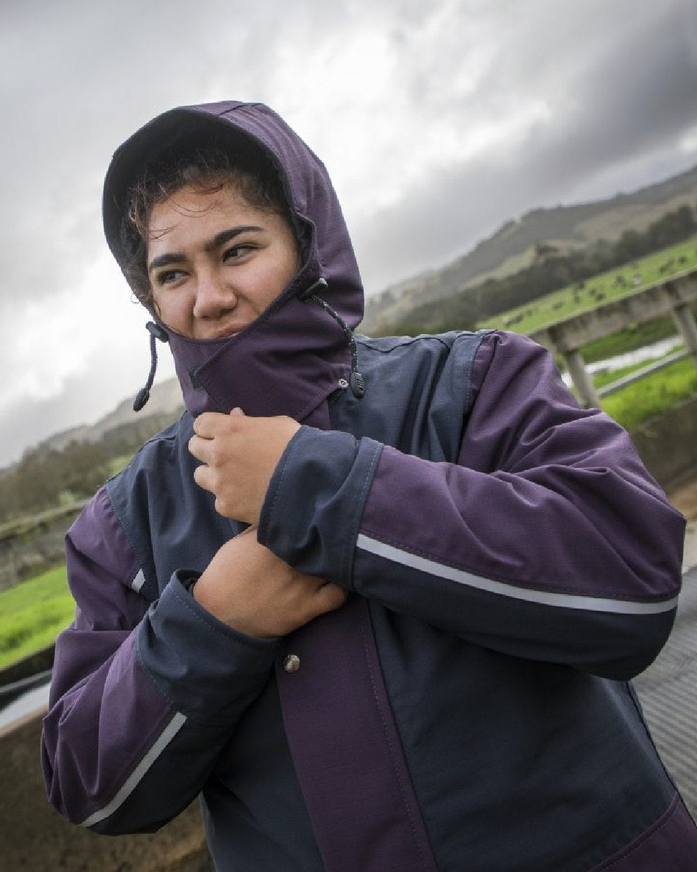 Navy coloured Kaiwaka Womens Stormforce Parka on sky background