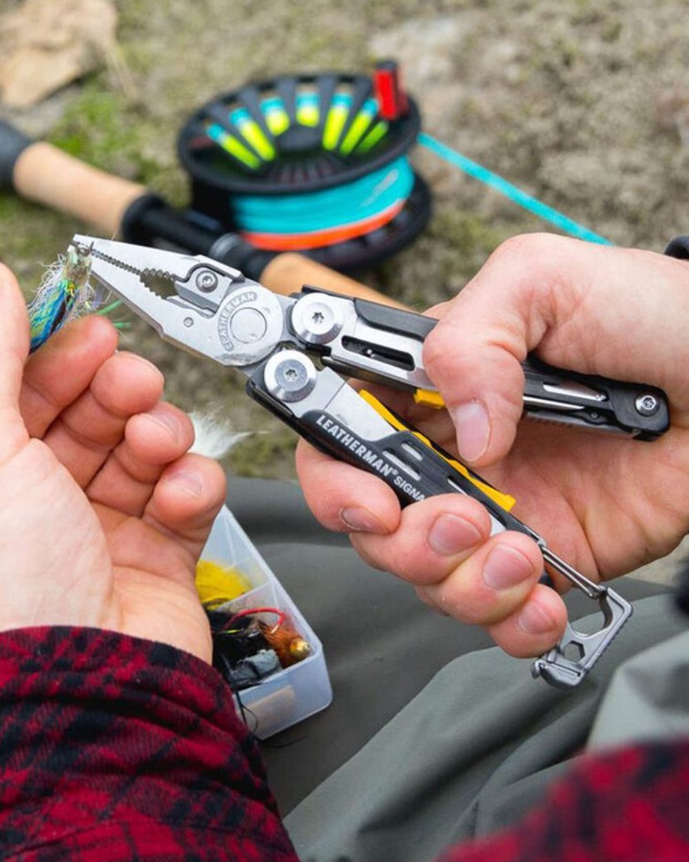 Stainless Steel Coloured Leatherman Signal+ Multi-Tool W/ Nylon Sheath On A Backyard Background