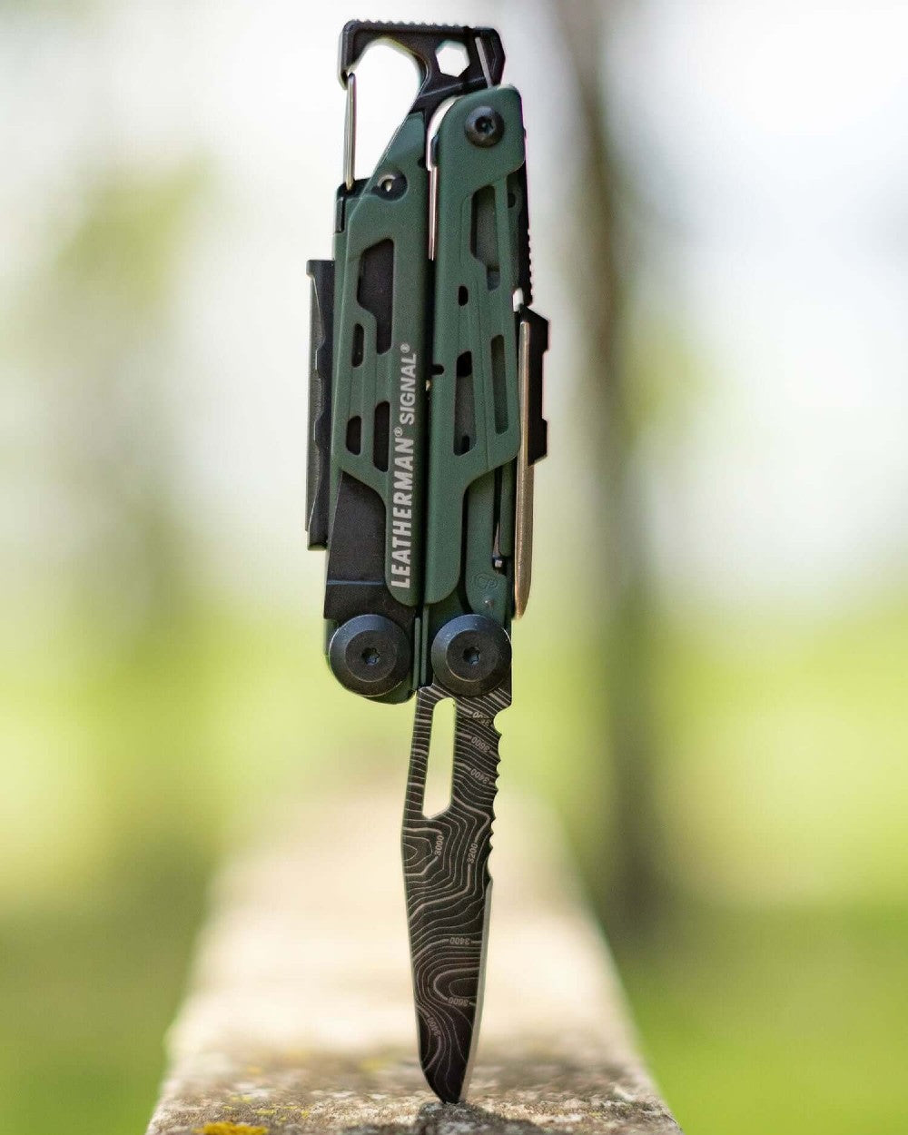 Topo Coloured Leatherman Signal+ Multi-Tool W/ Nylon Sheath On A Forest Background