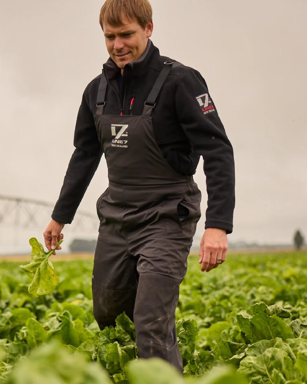 Black Coloured Line 7 Mens Territory Storm Pro20 Waterproof Bib Overtrouser on farm background