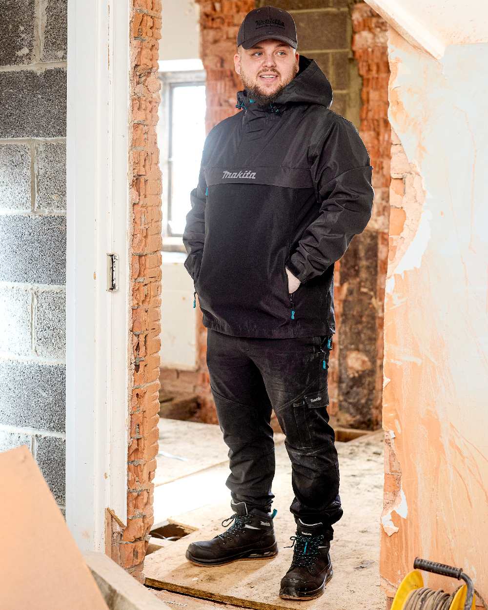 Black Coloured Makita Mens Axis Stretch Joggers on indoor background