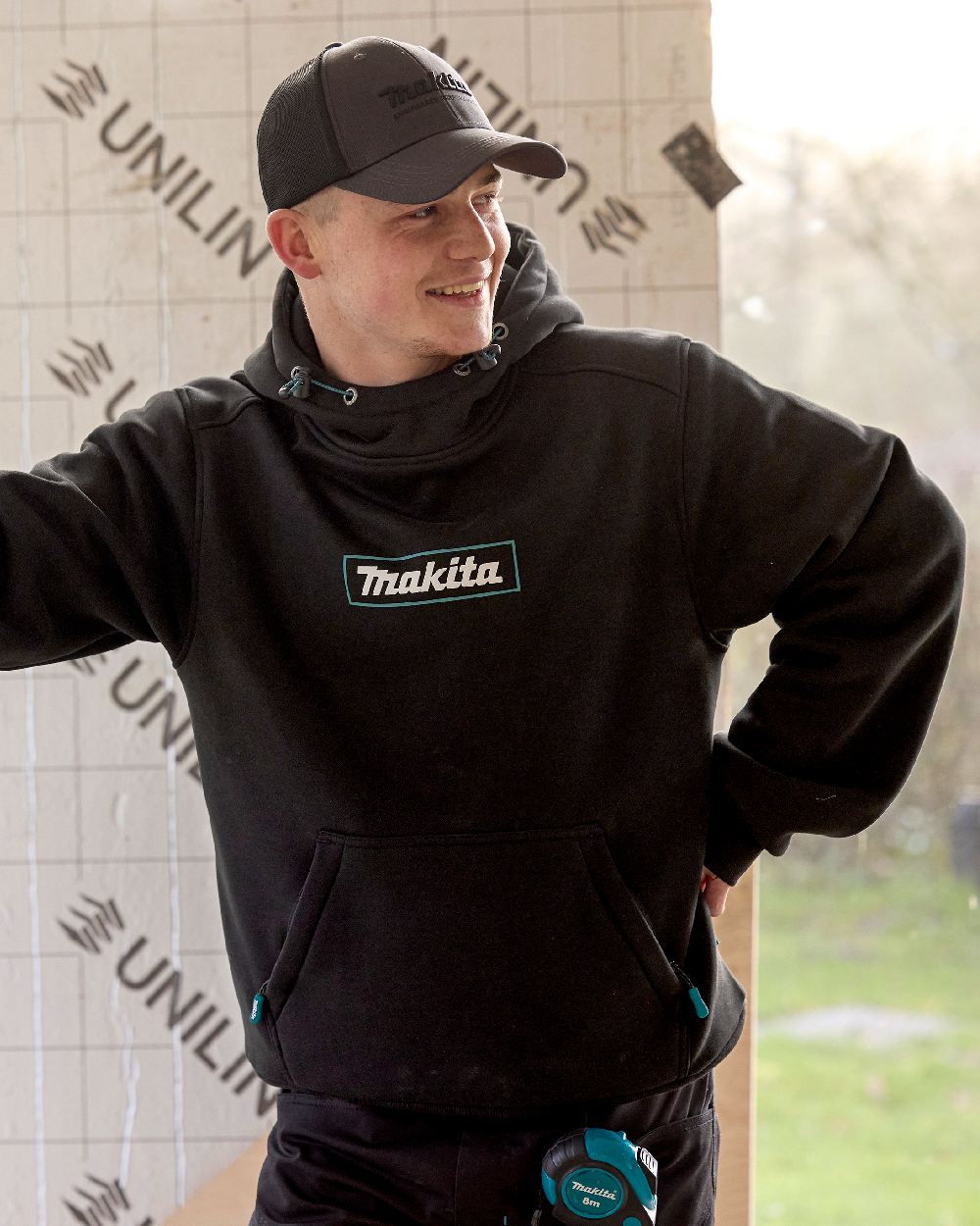 Black Coloured Makita Mens Origin Hoodie on construction background