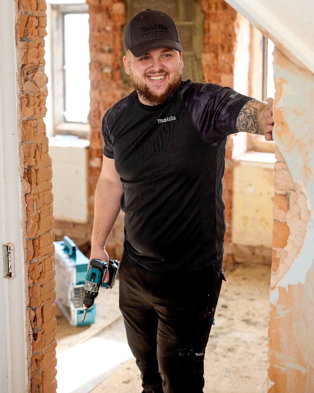 Black Coloured Makita Mens Tech T-Shirt on construction background