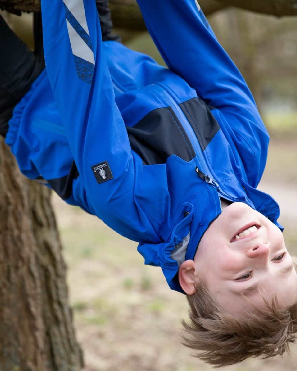 Azure Blue Dark Navy Coloured Mascot Workwear Childrens Accelerate Lightweight Outer Shell Jacket on outdoor background