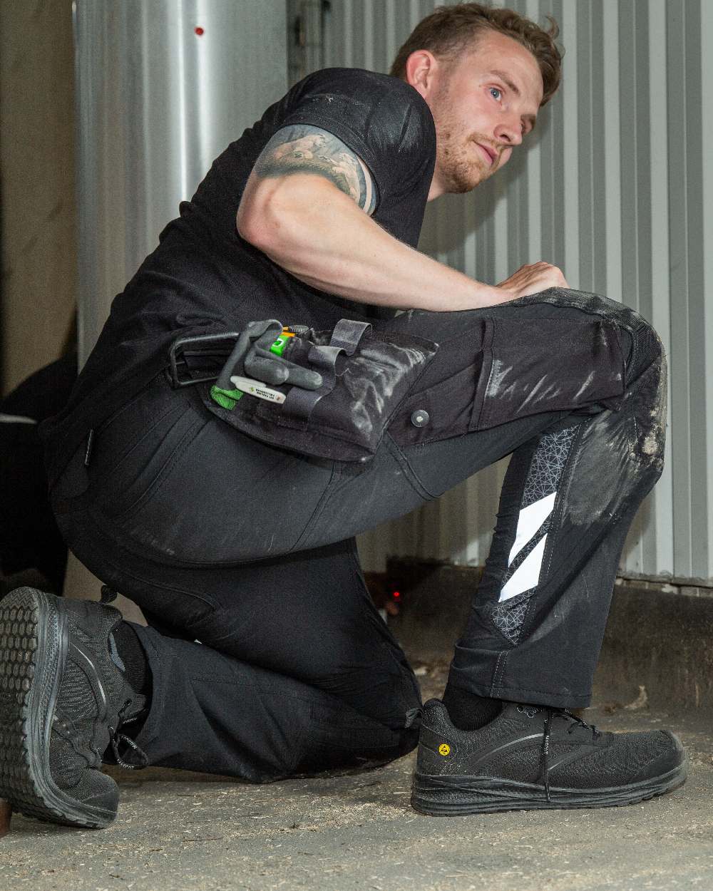 Black Coloured Mascot Workwear Mens Accelerate Lightweight Trousers With Holster Pockets on factory background