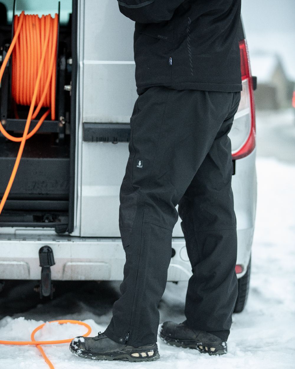 Black Coloured Mascot Workwear Mens Accelerate Waterproof Over Trousers on outdoor background