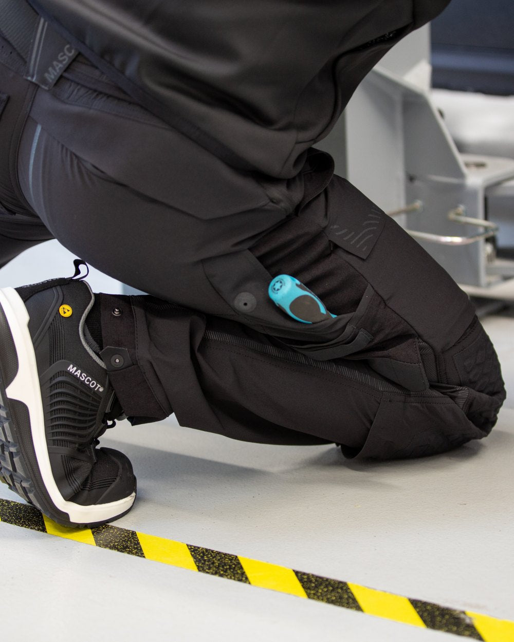 Black Coloured Mascot Workwear Mens Customized Ultimate Stretch Trousers on garage background