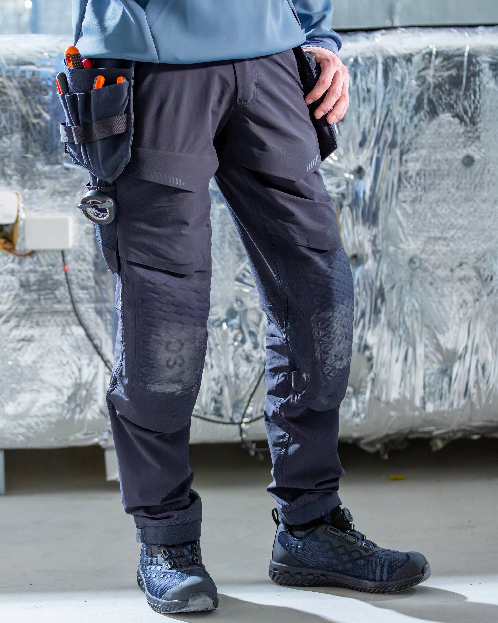 Dark Navy Coloured Mascot Workwear Mens Customized Ultimate Stretch Trousers on construction background