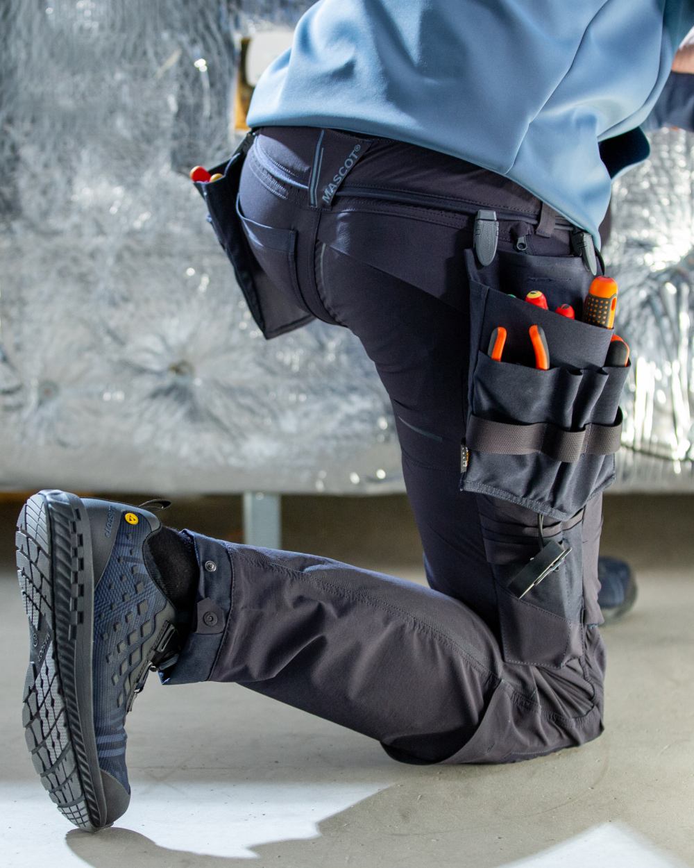 Dark Navy Coloured Mascot Workwear Mens Customized Ultimate Stretch Trousers on construction background