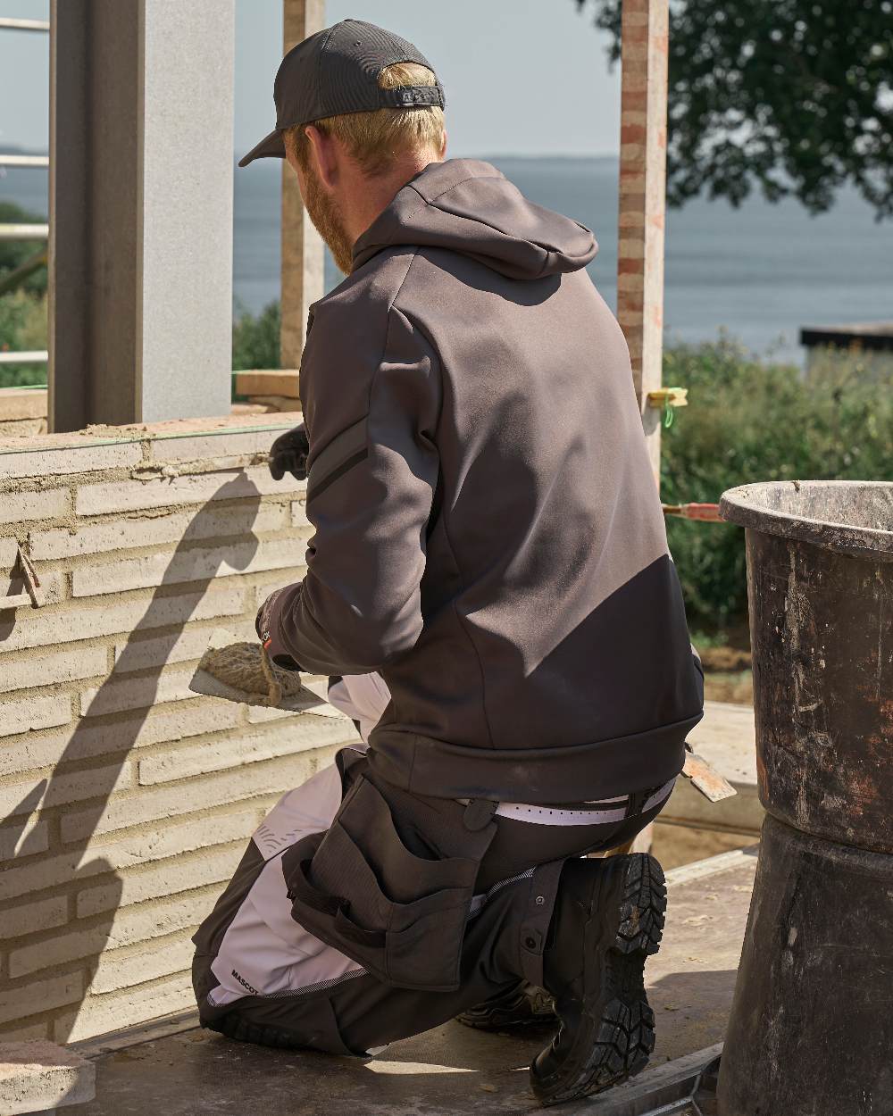 Stone Grey Coloured Mascot Workwear Mens Customized Water Repellent Fleece Hoodie on construction background