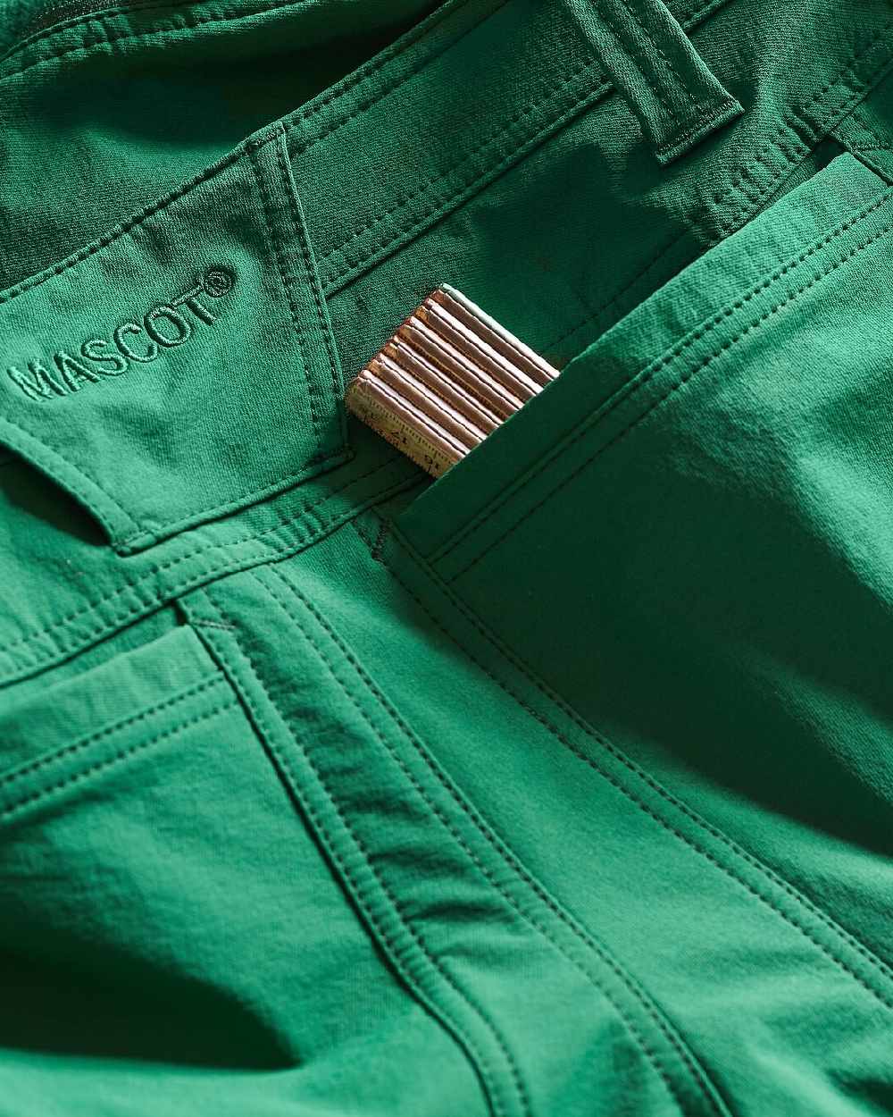 Green Coloured Mascot Workwear Womens Accelerate Trousers With Thigh Pockets on outdoor background