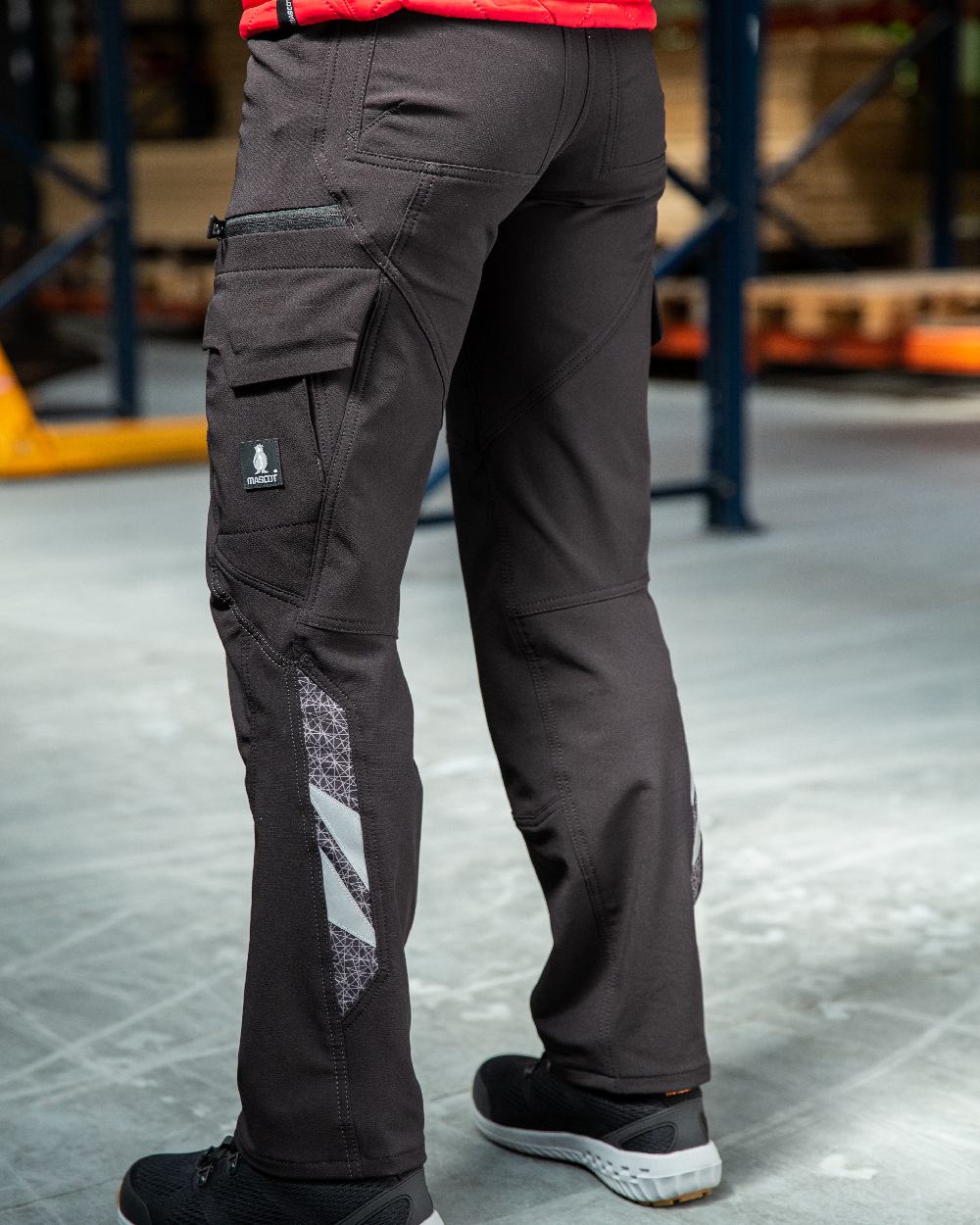 Black Coloured Mascot Workwear Womens Accelerate Ultimate Stretch Trousers on warehouse background