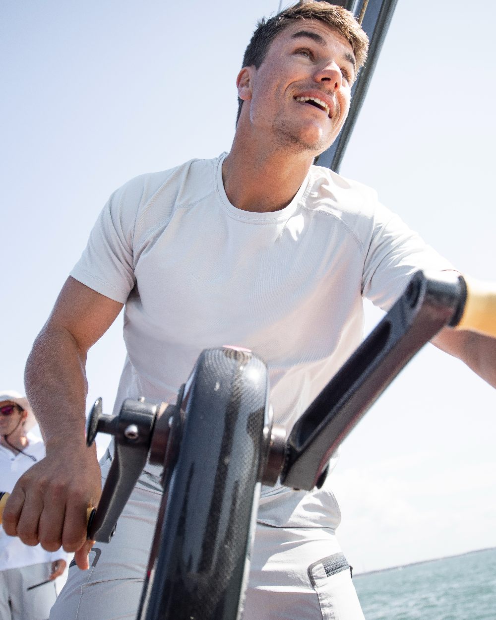 White coloured Musto Mens Sunblock Short Sleeve T-Shirt on Sailing background