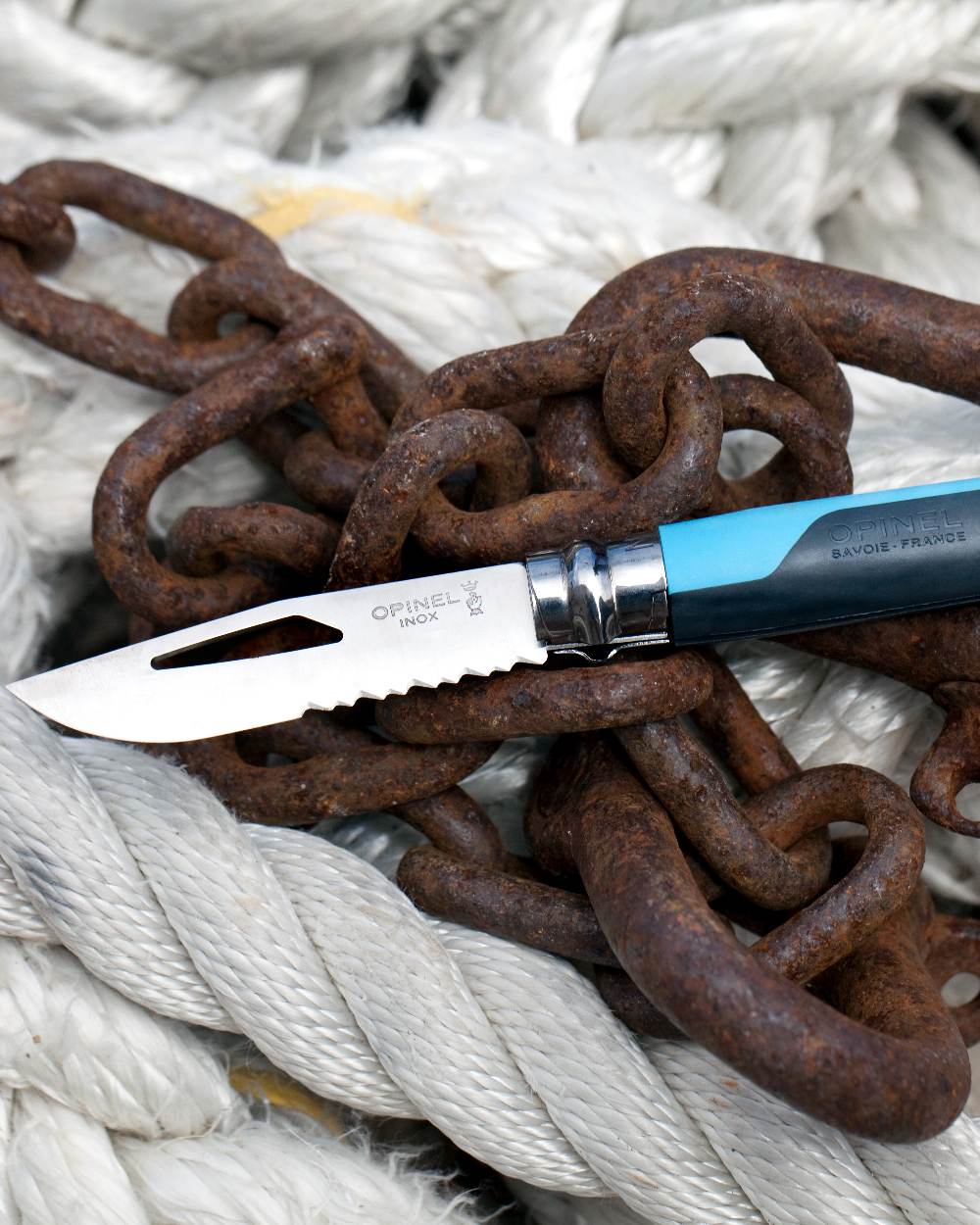 Blue coloured Opinel No.8 Outdoor Knife on rope background