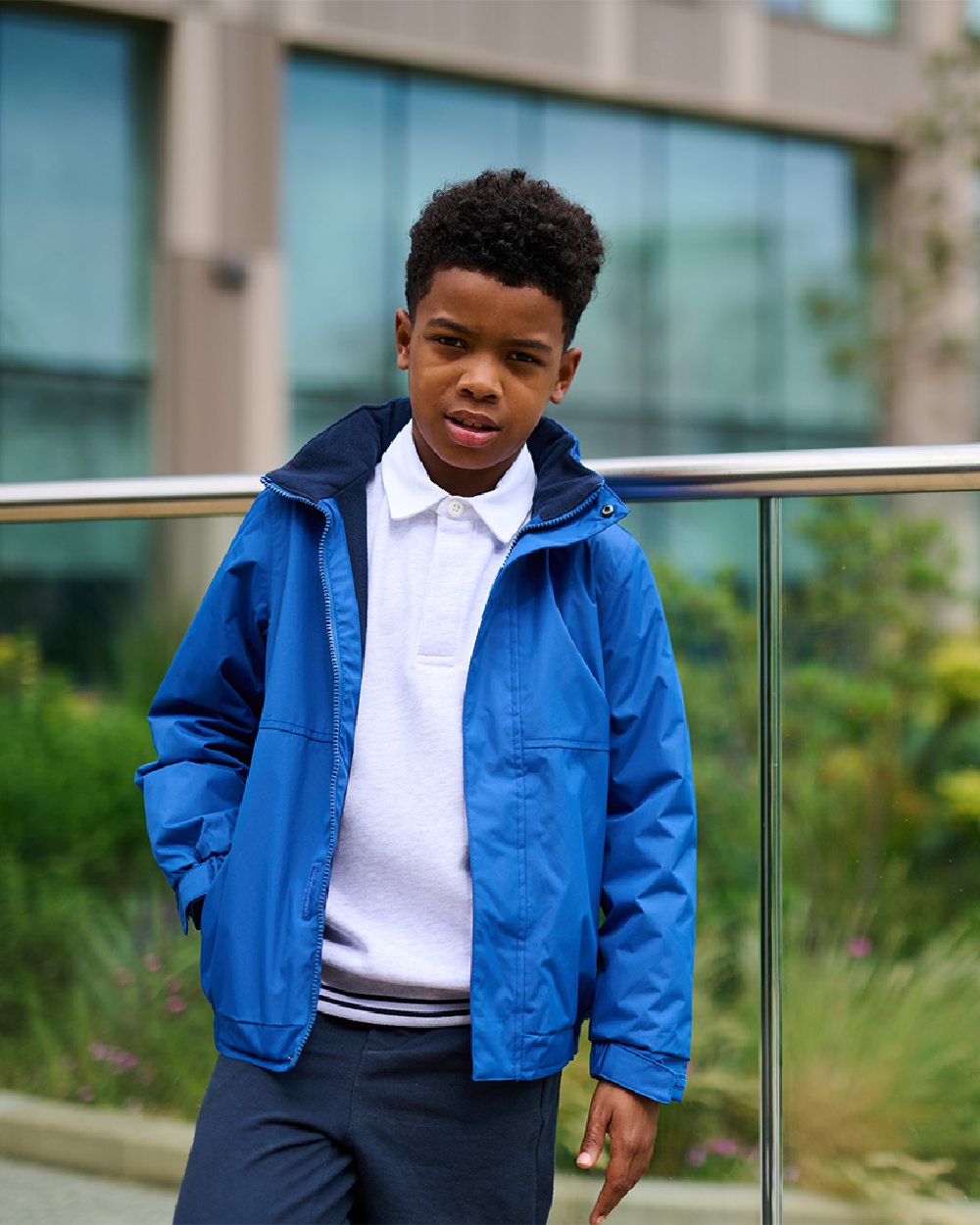 Royal Blue Navy coloured Regatta Kids Dover Fleece Lined Jacket on building background