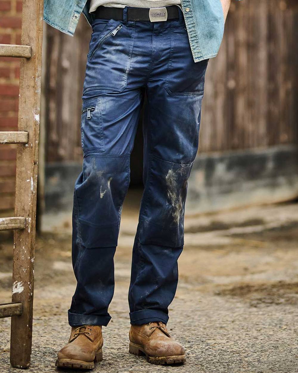 Navy coloured Regatta Pro Action Trousers on blurry background