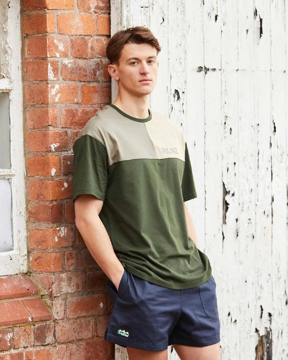 Navy coloured Ridgeline Hose Down Shorts on brick wall background